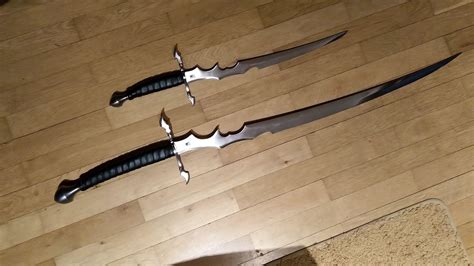 Pure fantasy pair of short sword/dagger and saber styled sword made by BKS (Baltimore Knife and ...