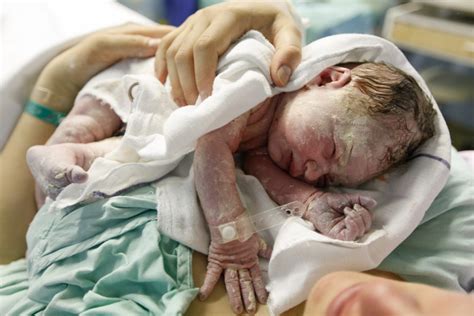 Why are newborn babies covered with a waxy white substance (vernix caseosa)