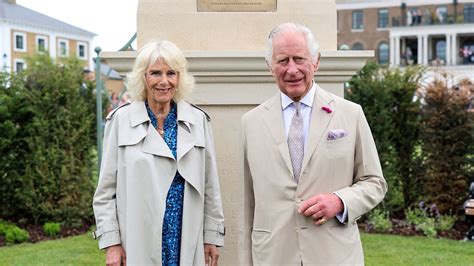 Queen Camilla's timeless trench coat and intriguing blue dress delights ...