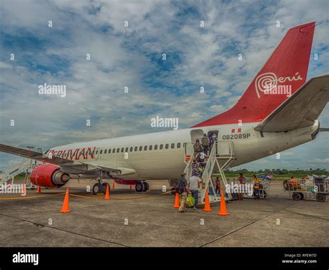 Iquitos, Peru - December 07, 2018: People entering into airplane at ...