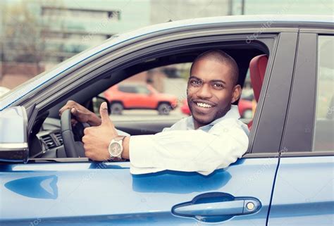 Man driver happy smiling showing thumbs up driving sport blue car — Stock Photo © SIphotography ...