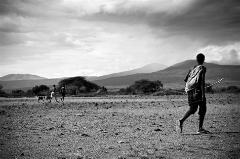 Hadzabe hunters and dogs in the scrub, Lake Eyasi, Tanzania. Traditionally, the Hadzabe do not ...