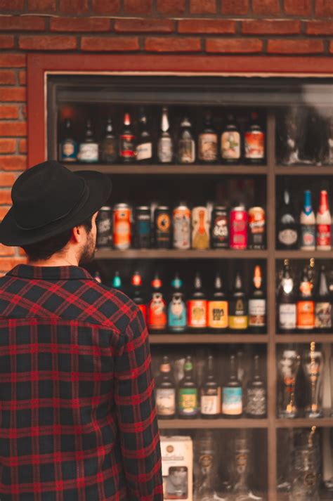 Man Looking at Liquor Bottles · Free Stock Photo