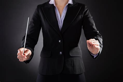 Female Orchestra Conductor With Baton Stock Photo - Download Image Now - iStock