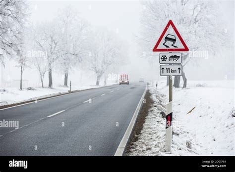 winter warning sign with snow Stock Photo - Alamy