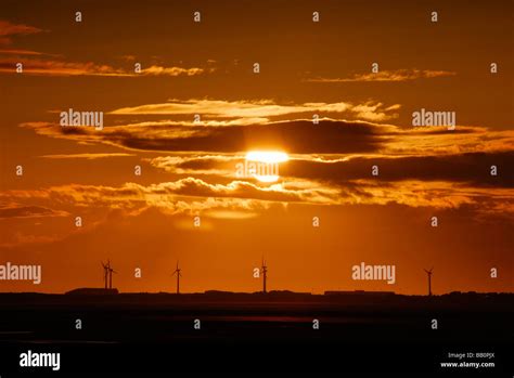 Sunset, wind turbines Stock Photo - Alamy