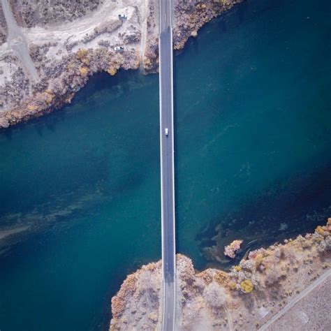 Aerial View of Car Driving on Highway Bridge Above Sea · Free Stock Photo