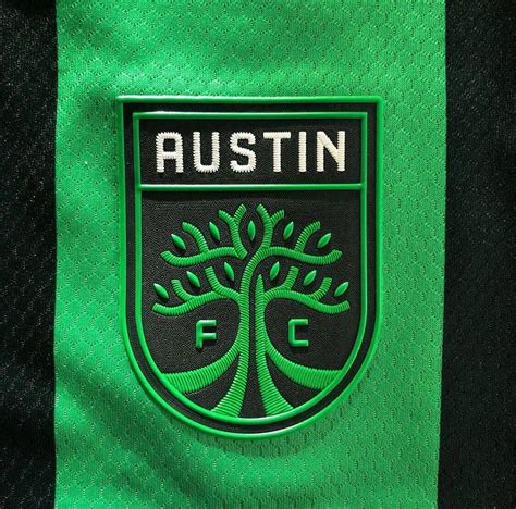 Download Austin FC Soccer Club Official Logo on Uniform Wallpaper | Wallpapers.com