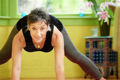 Older Caucasian woman practicing yoga - Stock Photo - Dissolve