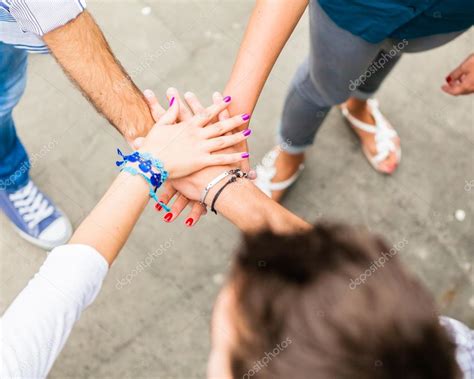 Group of friends holding hands in stack Stock Photo by ©GiorgioMagini ...