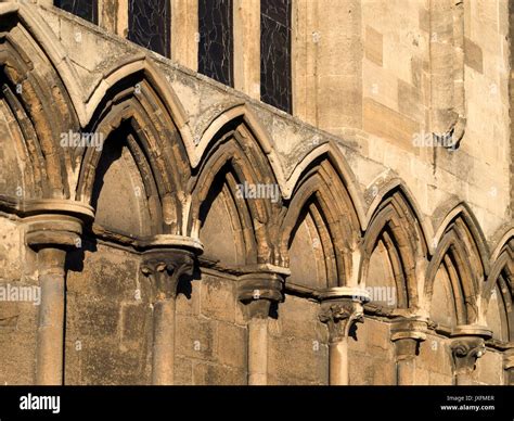 Row of old, stone pointed Gothic arches decorating exterior wall of All Saints Church, Stamford ...