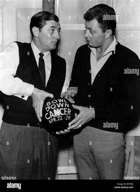 American actor Robert Mitchum and his son, Jim Mitchum, discussing ...