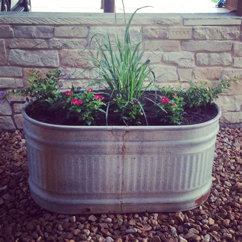 Old metal watering trough flower bed. | Garden troughs, Small front yard landscaping, Garden ...