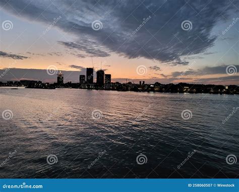 Beautiful Sunset Reflected on the Water of a Sea Over a Background of Buildings Stock Image ...