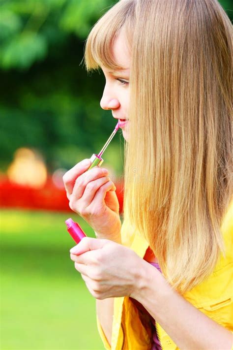 Applying lipstick stock photo. Image of outdoors, people - 11369658