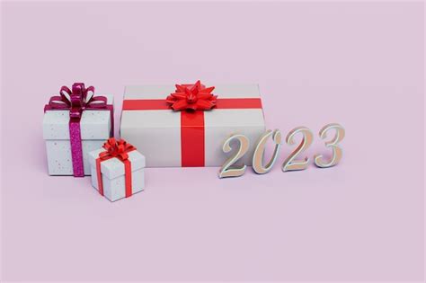 Premium Photo | Gifts for the new year 2023 gift boxes with red bows ...