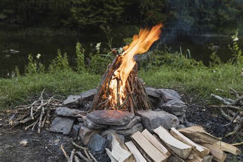 Campfire burning in stone circle stock photo