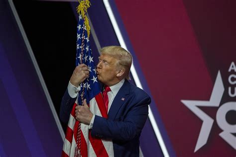 Watch Trump kiss and caress an American flag at CPAC: “I love you, baby”