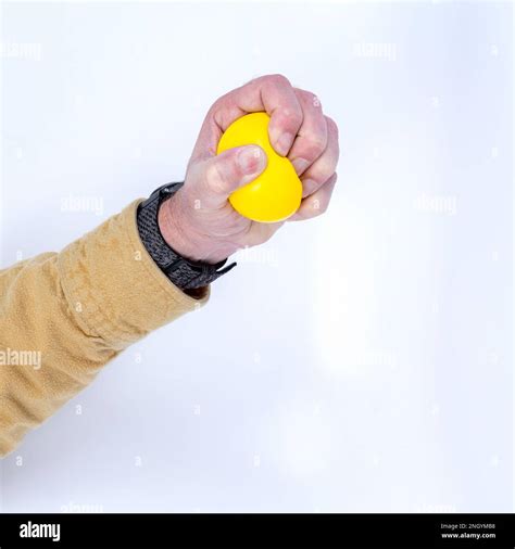 Yellow stress ball in use Stock Photo - Alamy