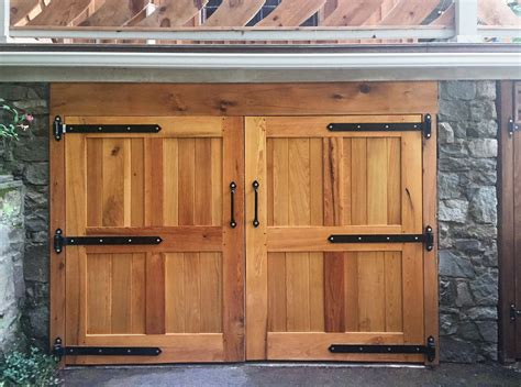 two wooden doors are open in front of a stone building