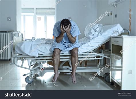 stock-photo-young-desperate-man-sitting-at-hospital-bed-alone-sad-and-devastated-suffering ...