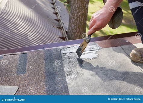 Repair and Construction. the Hands of the Worker Apply Mastic on the ...