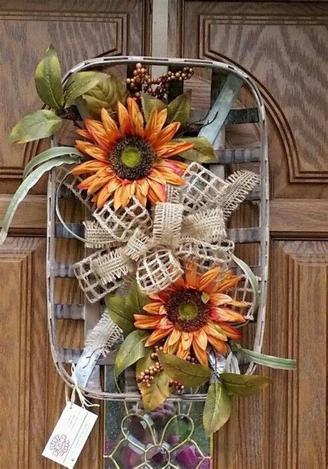 a metal basket with sunflowers and other decorations hanging on the front door handle