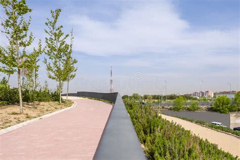 A Walkway with Red Brick Pavement and Metal Railing Stock Image - Image ...