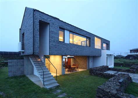 Z Lab uses volcanic stone for Jeju island holiday home | Holiday home, Building design, Jeju island