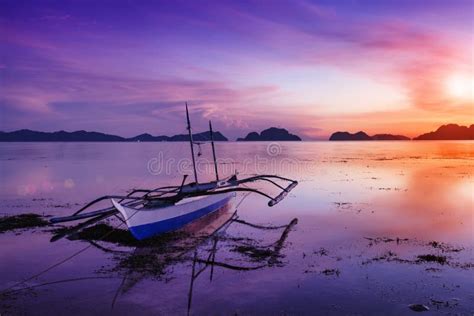 Sea, Beach, Waves, Palm Grove Illuminated Sunlight through the Clouds at Sunset. El Nido Palawan ...