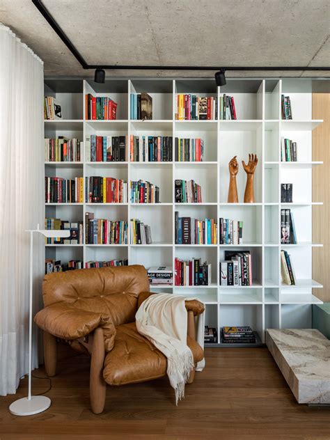 a living room filled with furniture and bookshelves covered in lots of different types of books