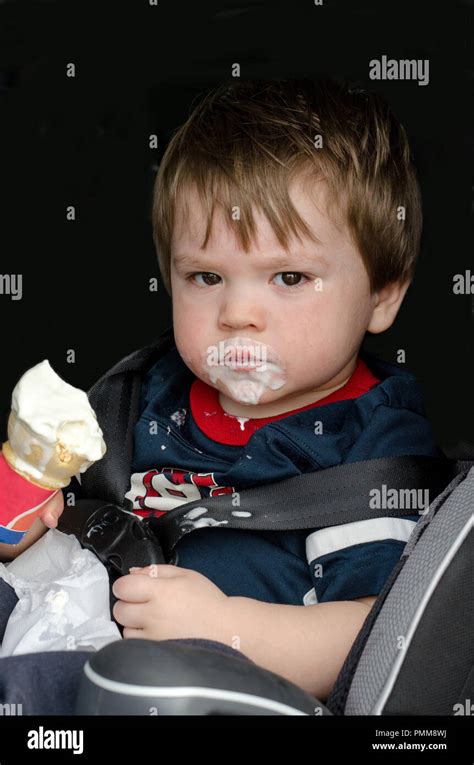 Messy toddler with ice cream cone Stock Photo - Alamy