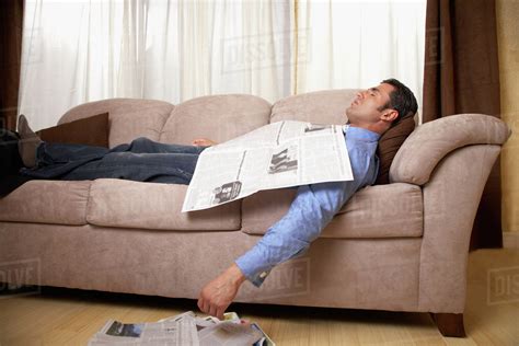 Hispanic man sleeping on sofa - Stock Photo - Dissolve