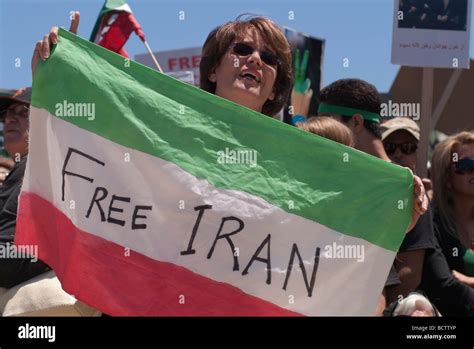 An Iranian woman holds an Iranian Flag with "Free Iran" written across ...