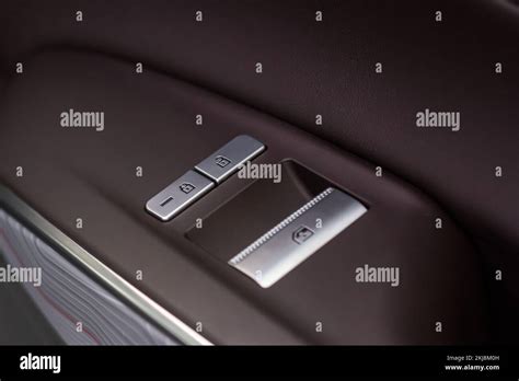 Car door lock unlock button close up. Modern car door lock. Door control panel in a new car ...