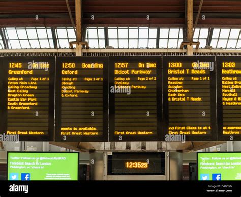 Electronic noticeboard showing train departures at Paddington Railway Station, London, England ...