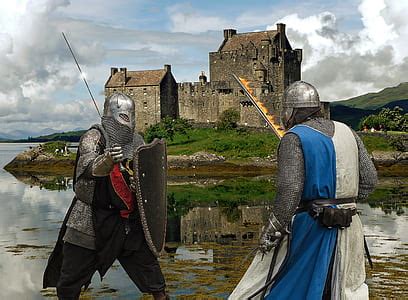 Royalty-Free photo: Two men wearing armor with castle background | PickPik