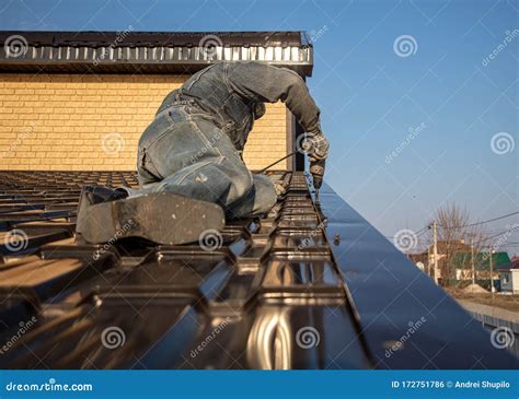 Installation of Metal Tiles on the Roof of the House Stock Photo ...