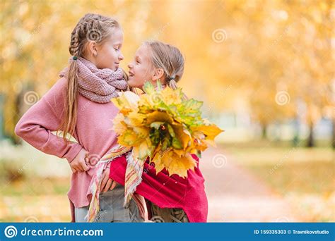 Little Adorable Girls Outdoors at Warm Sunny Autumn Day Stock Image - Image of autumnal ...