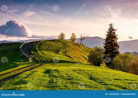 Country Road through Grassy Hill at Sunset Stock Image - Image of landscape, hill: 110769181