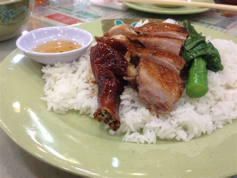 a green plate topped with rice and meat