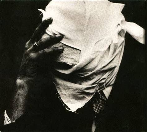 a black and white photo of a man with his head wrapped in a sheet over ...