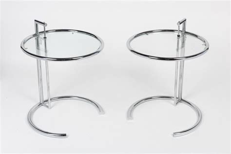 Lot - A pair of modernist chrome and glass side tables, after the ...