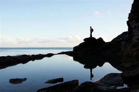 Hiker Looking Out To Sea From Coastal Photograph by Dougal Waters - Fine Art America