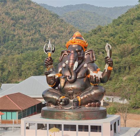 Giant Hindu God Ganesh on top of the building in a temple in Tha by pinkblue Vectors ...