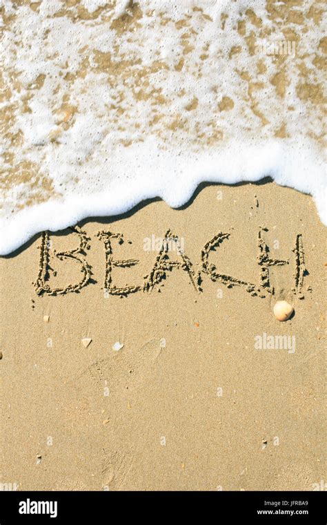 Letter drawn on the sand beach Stock Photo - Alamy