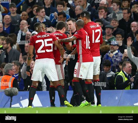 Manchester United's players surround referee Michael Oliver after Ander ...