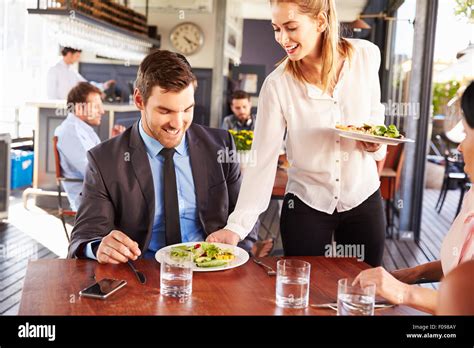 Business man being served food in a restaurant Stock Photo - Alamy