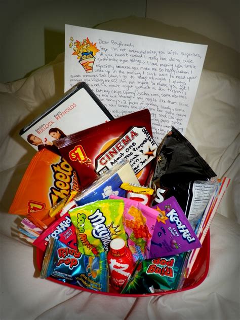 a basket filled with candy and snacks on top of a bed