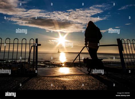 Sunderland, UK. 19th Dec, 2017. UK Weather: A woman walks her dog on a ...